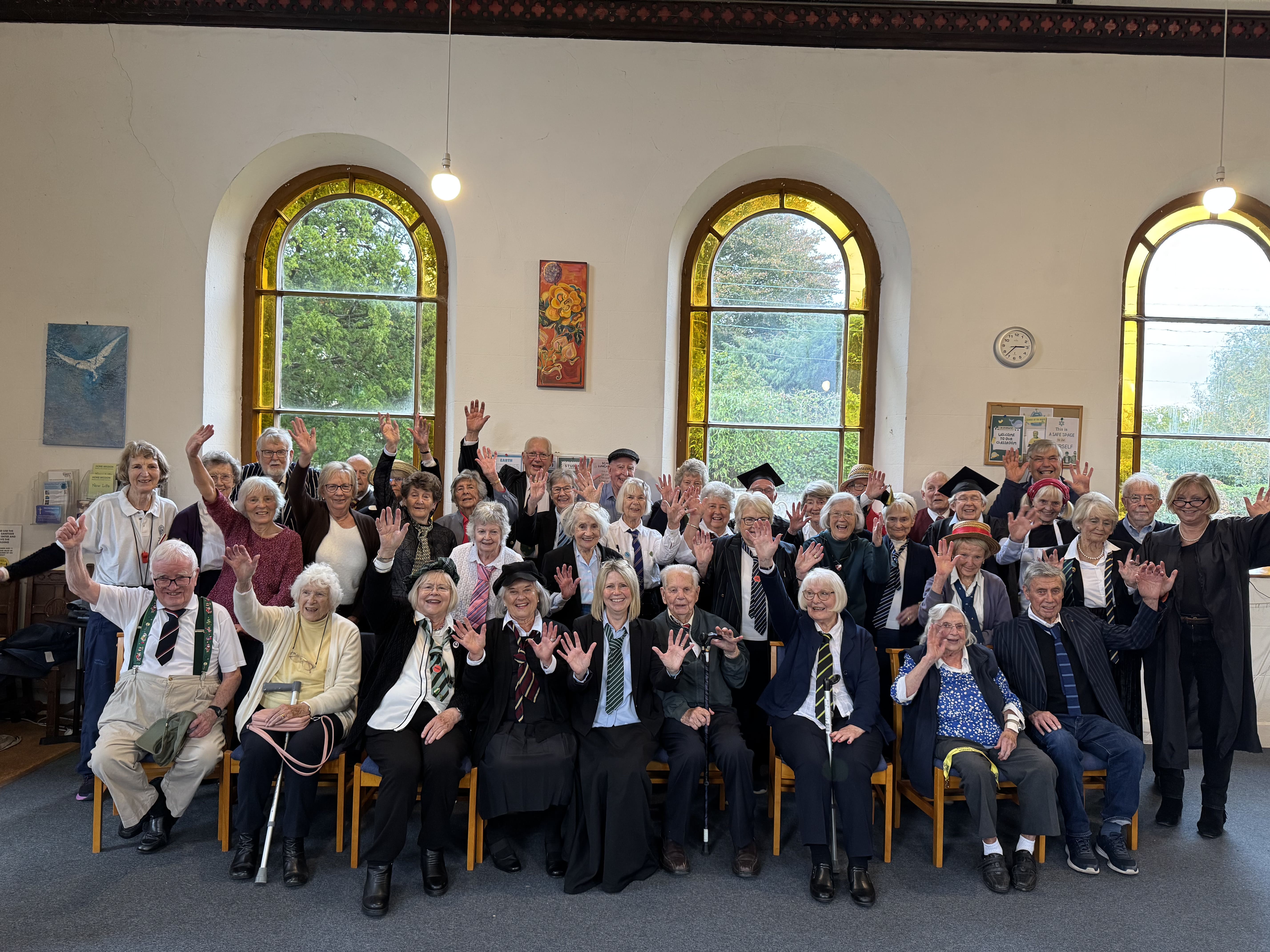 Chew Chat members waving at the camera during a themed event