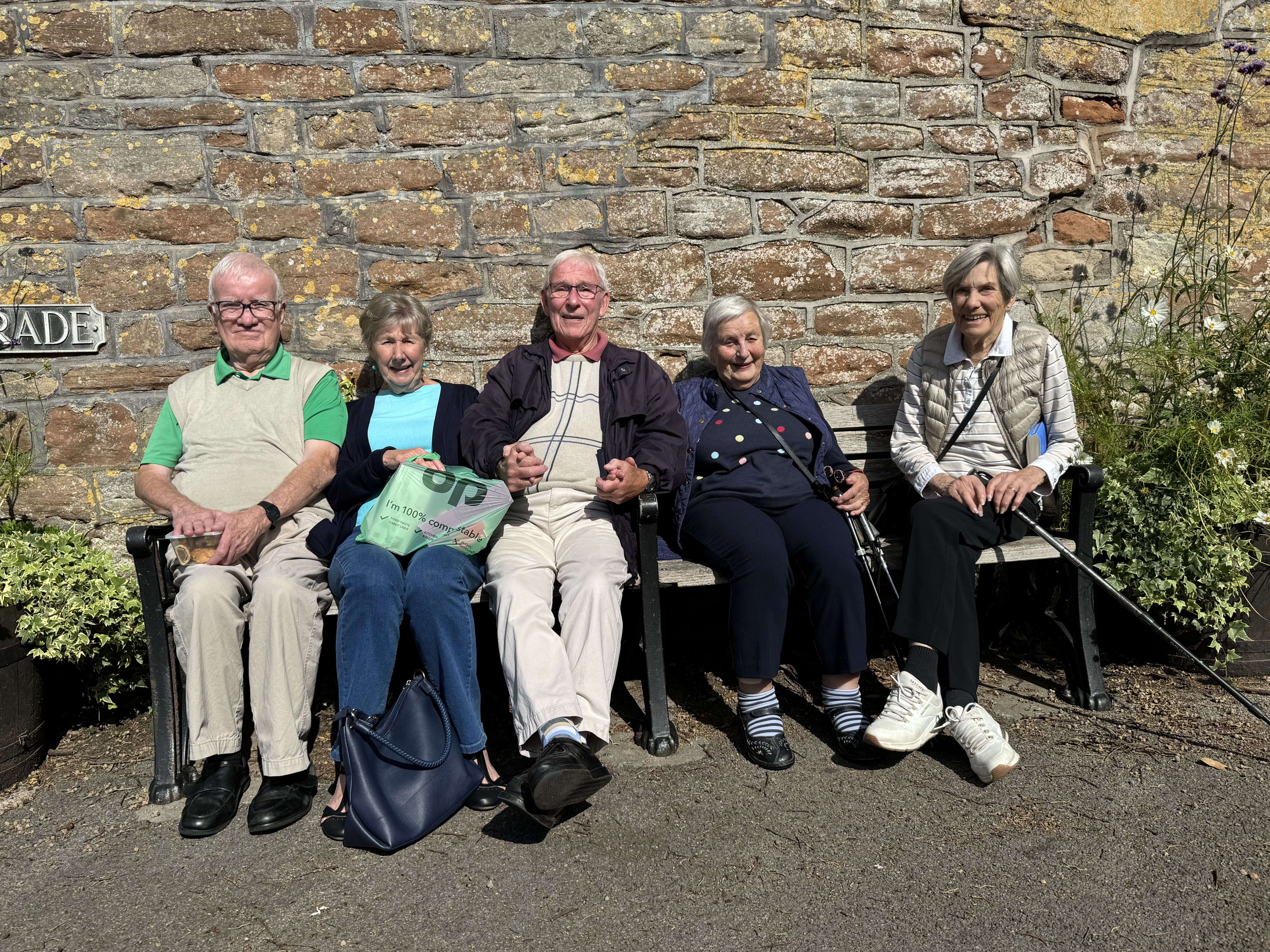 Members relaxing on a bench